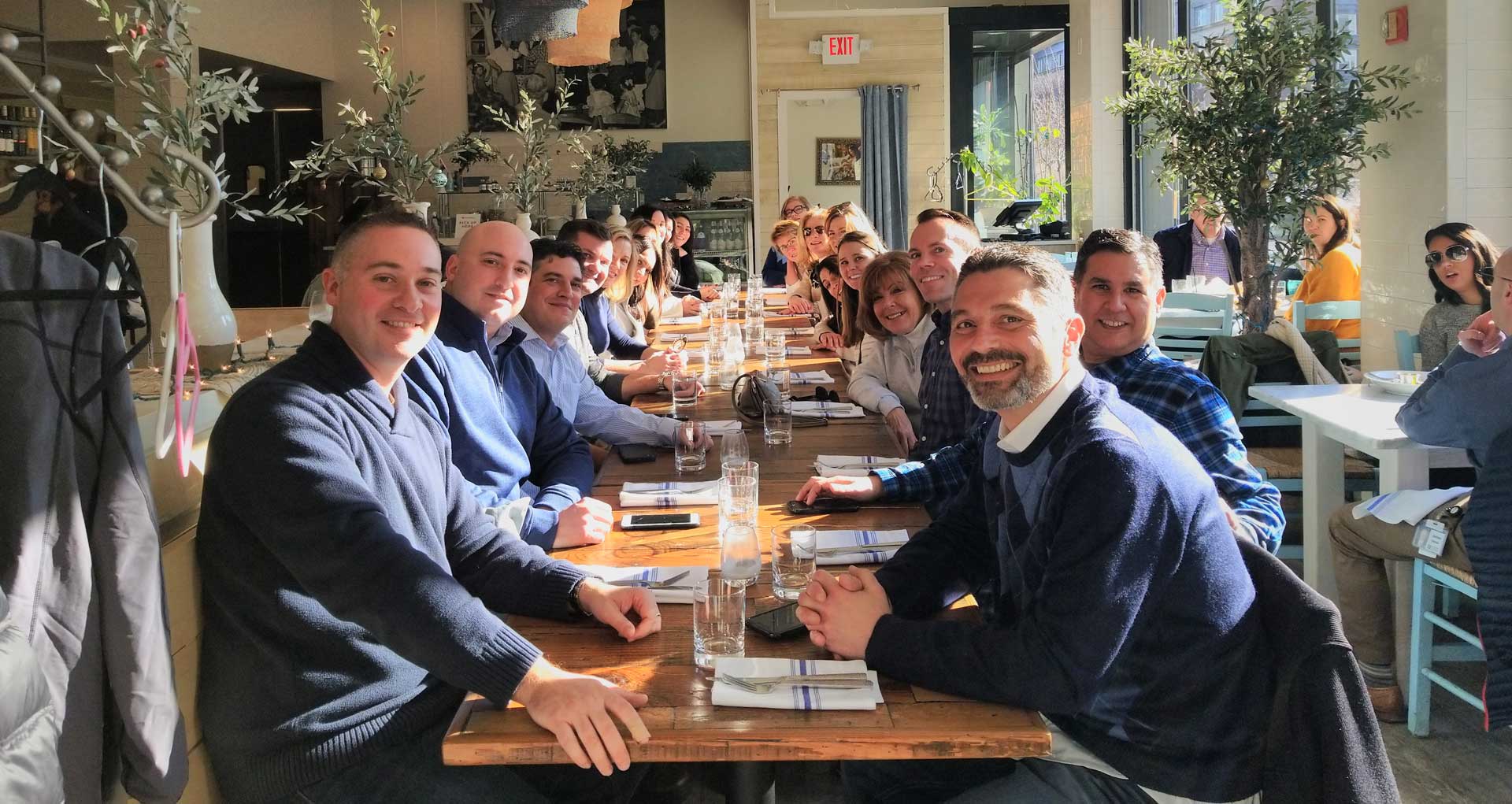 Group of tourists enjoying a delicious meal - an experience included in the Providence's Very Delicious Lunch Tour.