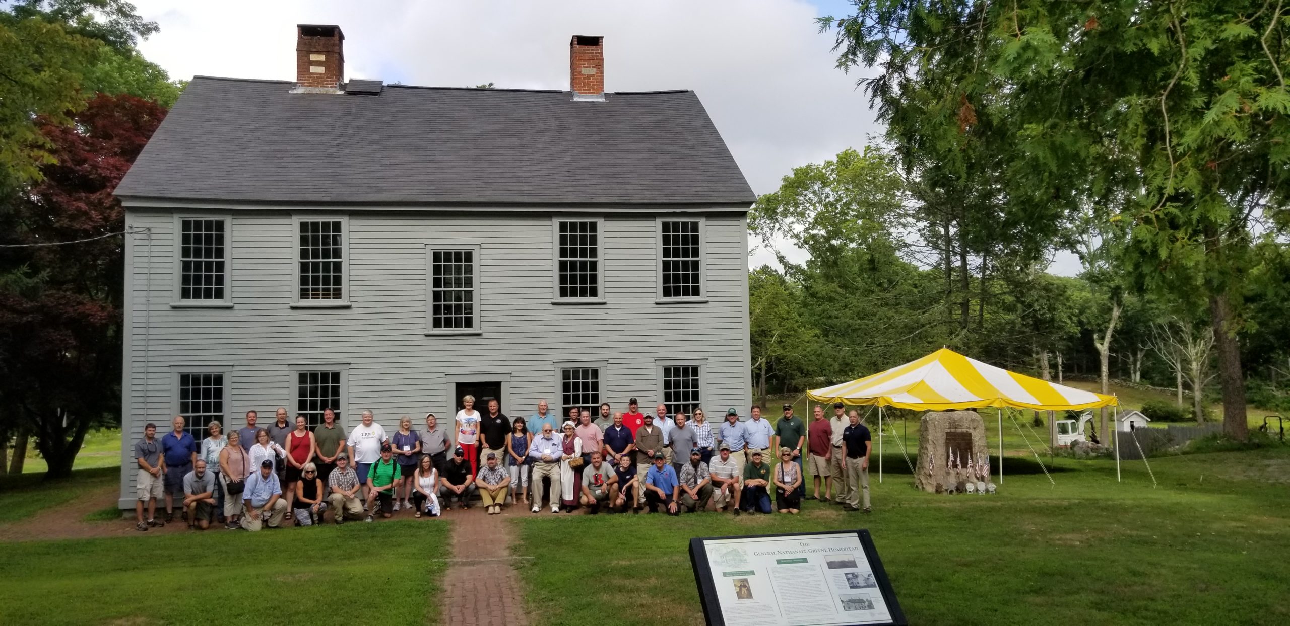 Group picture of tourists with the view of the General Nathanael Greene Homestead, Coventry, Rhode Island. Homestead, Coventry, Rhode Island.