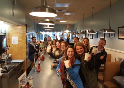 Tourists posting with their favorite drinks - an experience included in the Taste of Rhode Island Tour.
