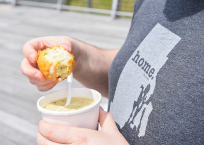 Close up view of woman holding a Beignet - among the many to foods included in the Taste of Rhode Island Tour.