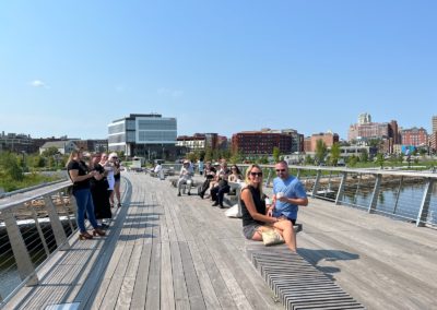 Tourists taking a break at the Providence Pedestrian Bridge - an experience included in the Taste of Rhode Island Tour.