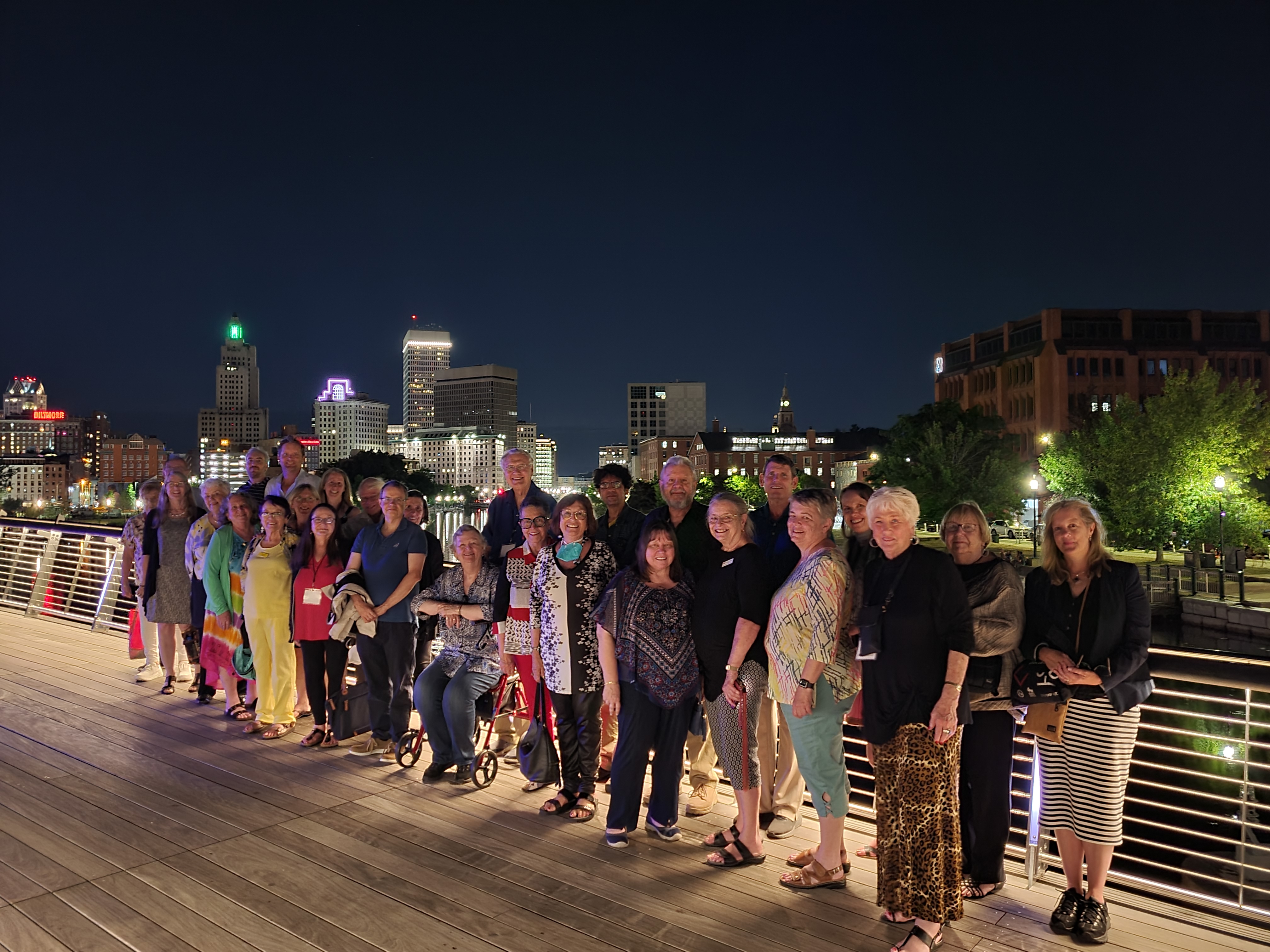 Tourists on the Providence Pedestrian Bridge at night - an experience included in the An Evening in the City Tour.