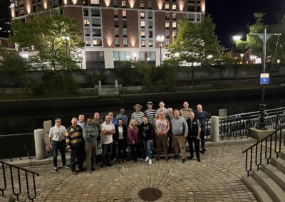 Group picture of tourist with the view of the Waterplace park at night.