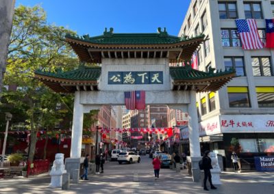 Front view of the China Town Gate in Boston, Massachusetts, with the flags of China and USA hang on the arch.