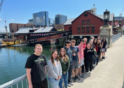 Tourists posing at the Entrance at Boston Tea Party Ships & Museum - an experience included in the Best of Boston Tour.