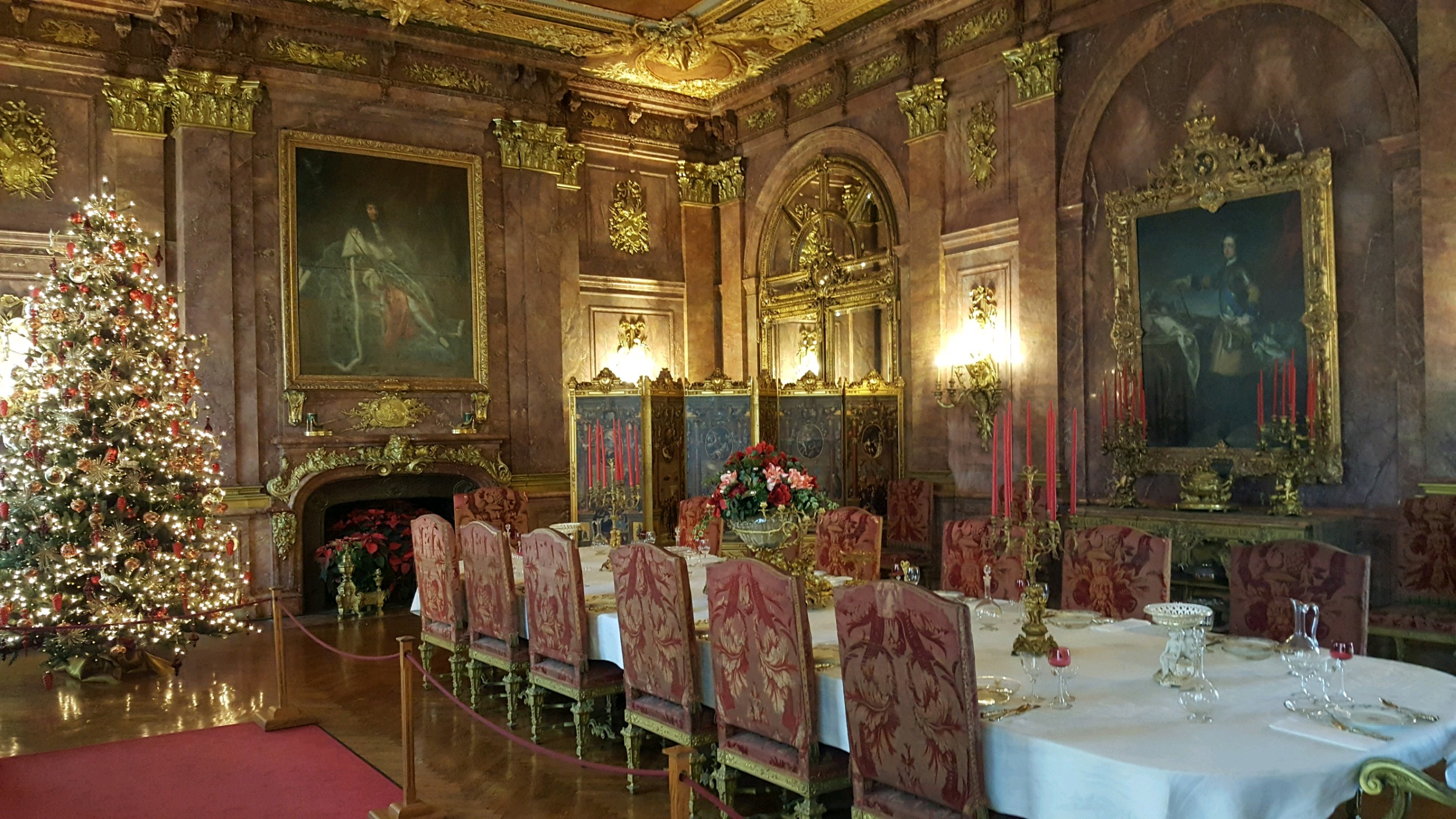 Dining room with Christmas tree filled with lights on the side of the Marble House, a Gilded Age mansion in Newport, RI.