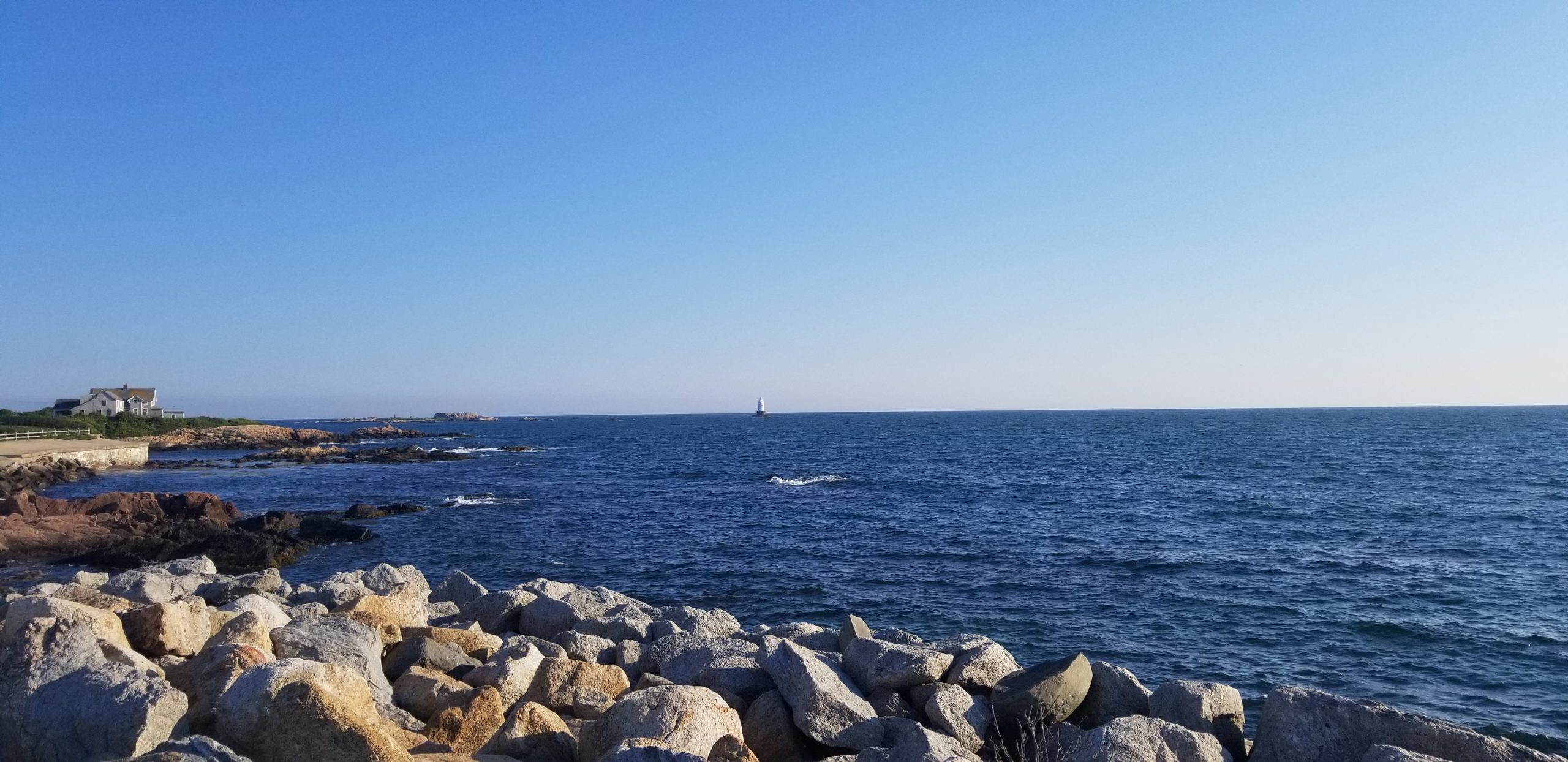 View of the lighthouse at Breakwater Point, Little Compton, Rhode Island - an experience included in the Tour.