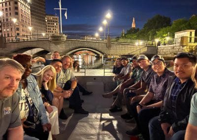 Tourists approacing the Providence Pedestrian Bridge on a tour boat - an experience included in the Dinner and a Cruise Tour.