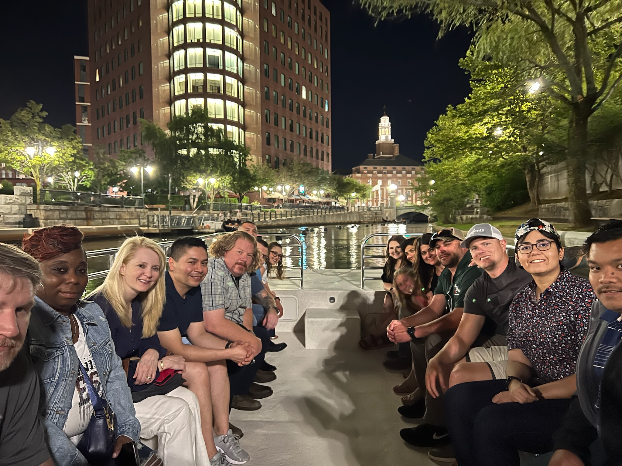 Group of people on a cruise facing the One Citizens Plaza by the Providence River - included in the Dinner and a Cruise Tour.