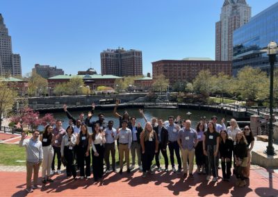 Group picture of tourists with the view of the Providence River - an activity included in the Discover Providence Tour.