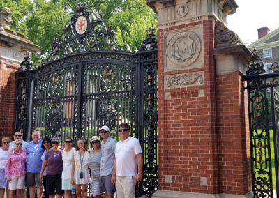 Group picture of tourists at the Van Wickle Gates of Brown University - a view included in the Discover Providence Tour.