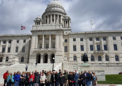 Group picture of tourists at the Rhode Island State House - a destination included in the Discover Providence Tour.