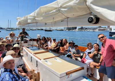 Tourists enjoying a harbor sightseeing trip - an experience included in the Newport Sail & lunch at Sweet Berry Farm Tour.