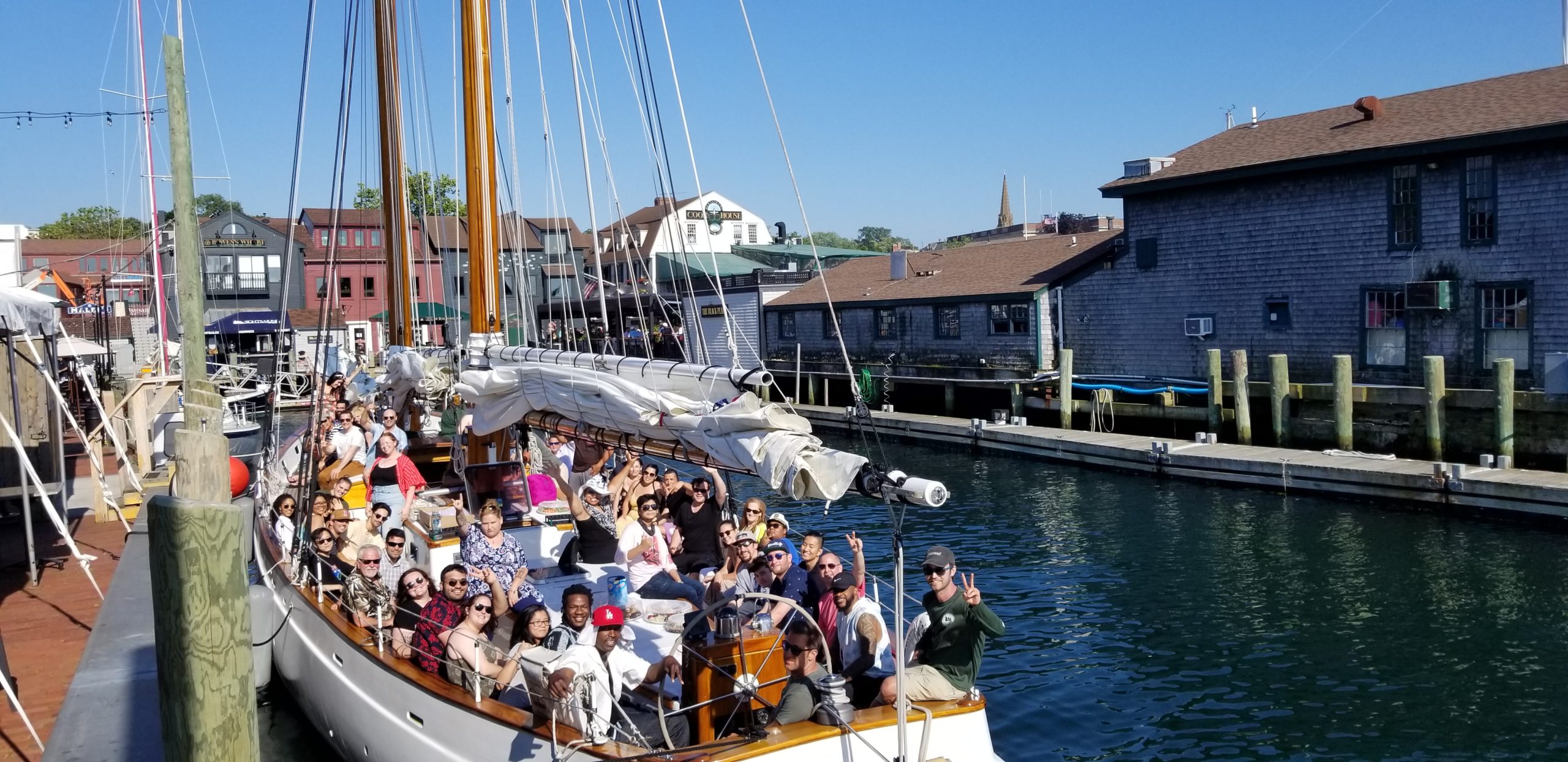 Group of tourists aboard a yacht at Bannister's Wharf - an experience included in the Newport Sail Tour.