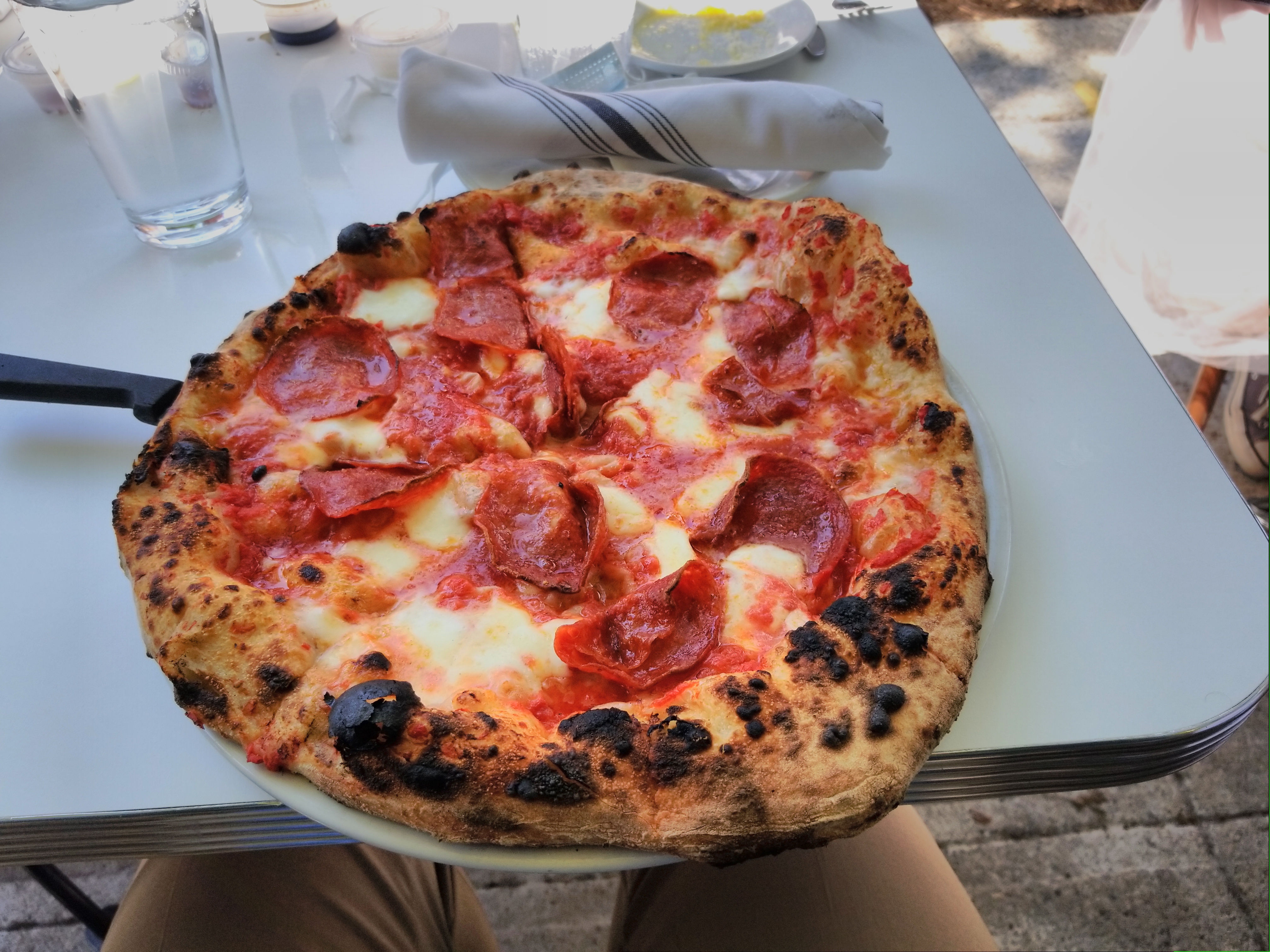 The best Italian round pizza served on a table - an experience included in the Providence's Very Delicious Lunch Tour.