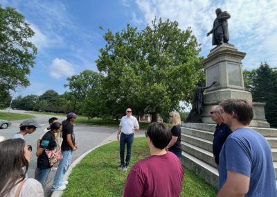 Tourists gathering at the Statue of Roger Williams - a destination included in the Rhode Island in a Day Tour.