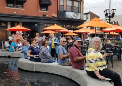 Group of tourists eating beside the Federal Hill Fountain at the DePasquale Square - included in the Taste of Rhode Island