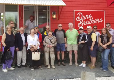 Group picture of tourists at the Dune Brothers Seafood Restaurant - a destination included in the Taste of Rhode Island Tour.