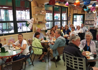 Tourists enjoying an Italian snack in Providence, RI - an experience included in the The Italian Experience Tour.