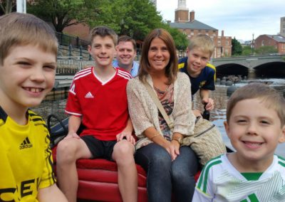 A Family on Gondola Ride along the Providence River - an experience included in The Italian Experience Tour.