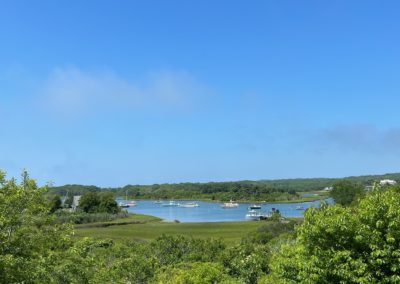 Aerial View of the Menemsha Pond with sailboats sailing - a destination included in the A Day on Martha’s Vineyard Tour.