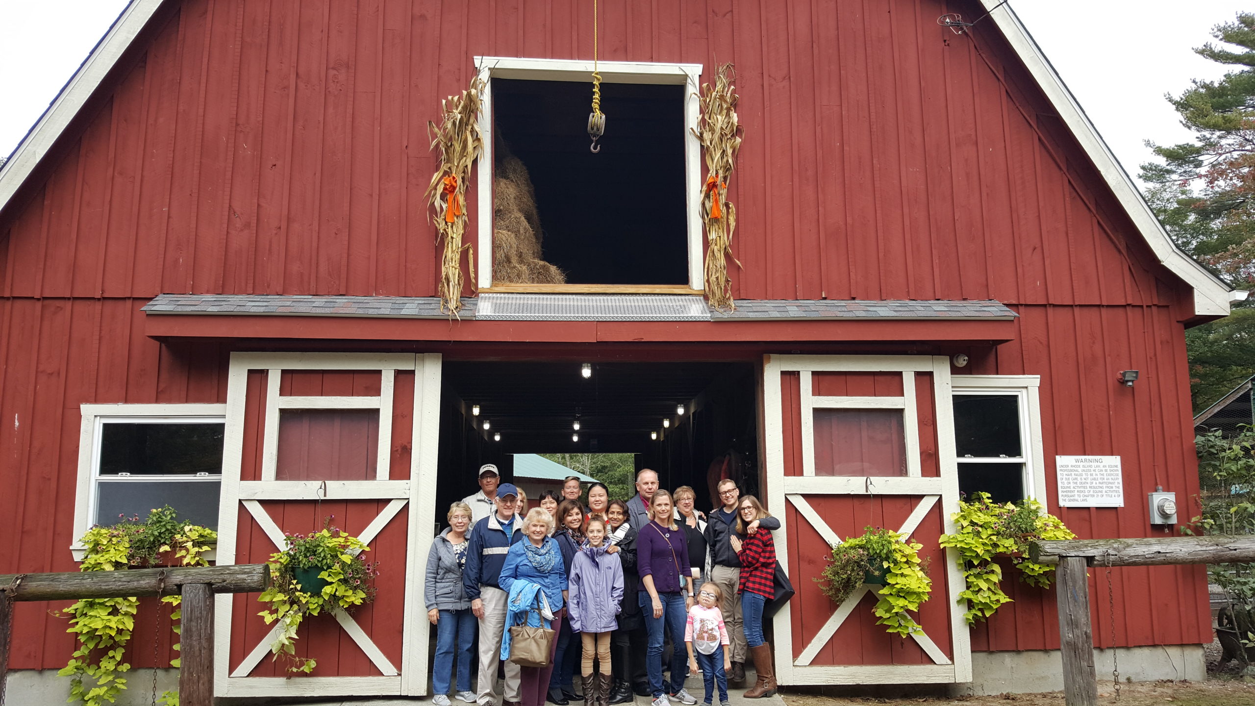 Group photo at a classic fall red barn in New England.