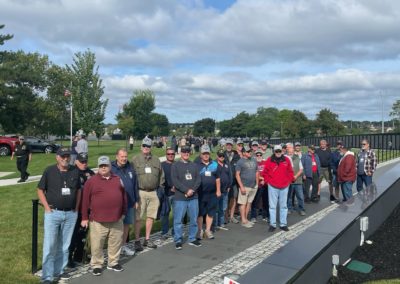 Group picture of tourists at the Veterans Memorial Bicentennial Park, Fall River, MA - included in the A Military Experience Tour.