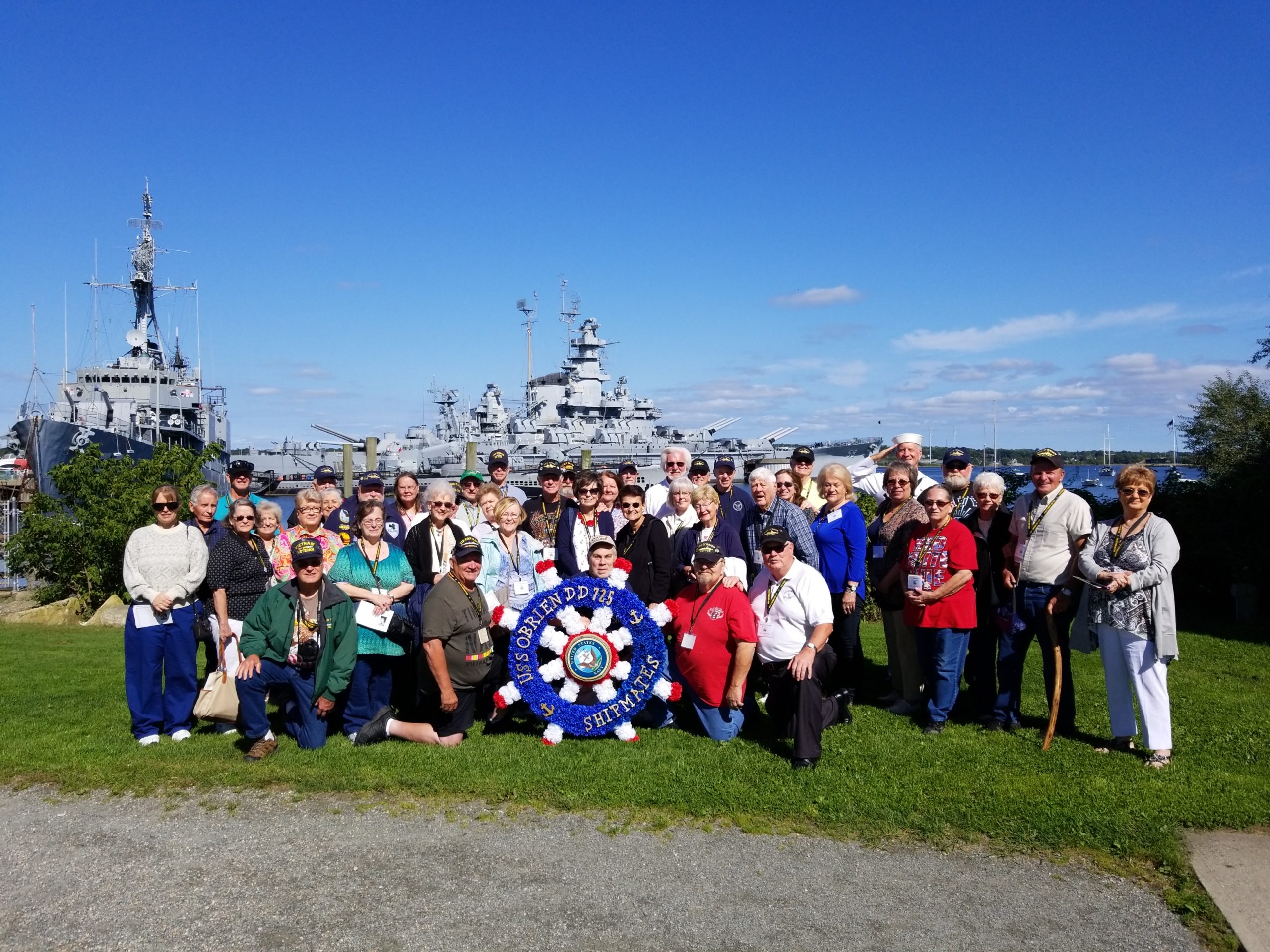 Group photo with the view of USS Massachusetts at the Battleship Cove in Fall River, MA.