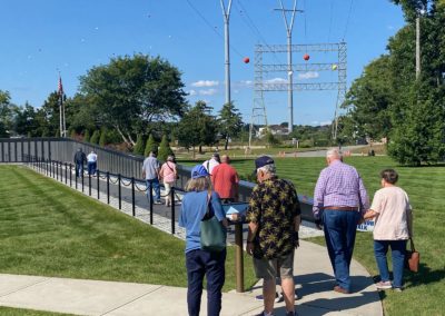 Group of elderly tourists walking inside the Vietnam Veterans Memorial Park, Warwick, RI.