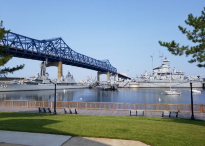 View of the Braga Bridge and USS Massachusetts docked at the Battleship Cove, Fall River, MA. - a destination included in the A Military Experience Tour.