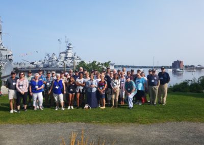 Group picture with the view of USS Massachusetts Newport, RI.