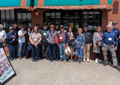 Tourists posing at an Italian Restaurant selling Tony's Zeppoles - a destination included in the Italian Experience Tour.
