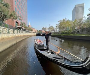Gondola Ride - The Italian Experience Tourists onboard a black Gondola sailing the Providence River - an activity included in the Italian Experience Tour.