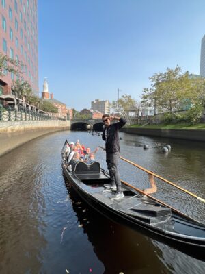 Gondola Ride - The Italian Experience Tourists onboard a black Gondola sailing the Providence River - an activity included in the Italian Experience Tour.